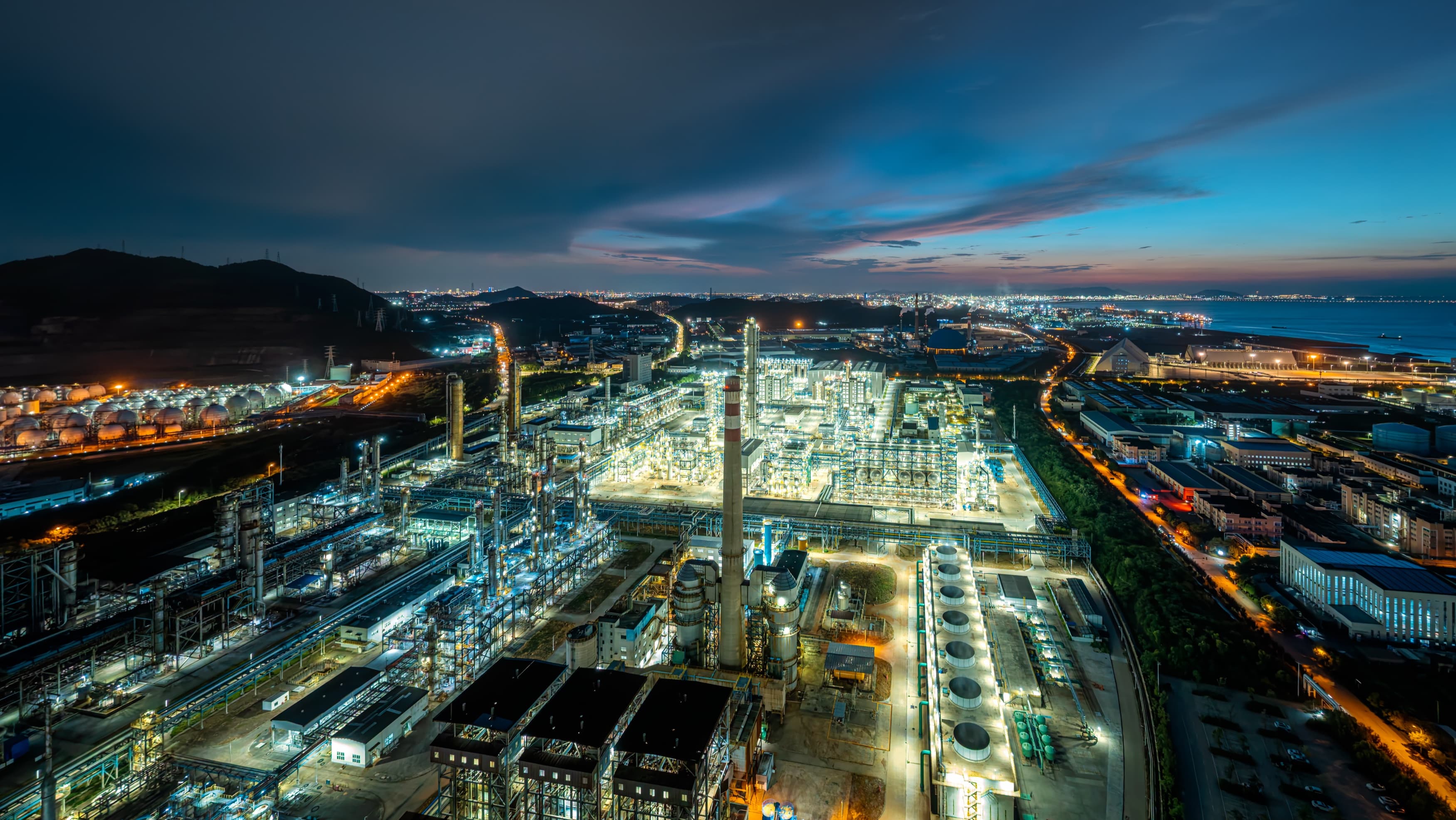 Aerial view of an illuminated energetics complex at dusk